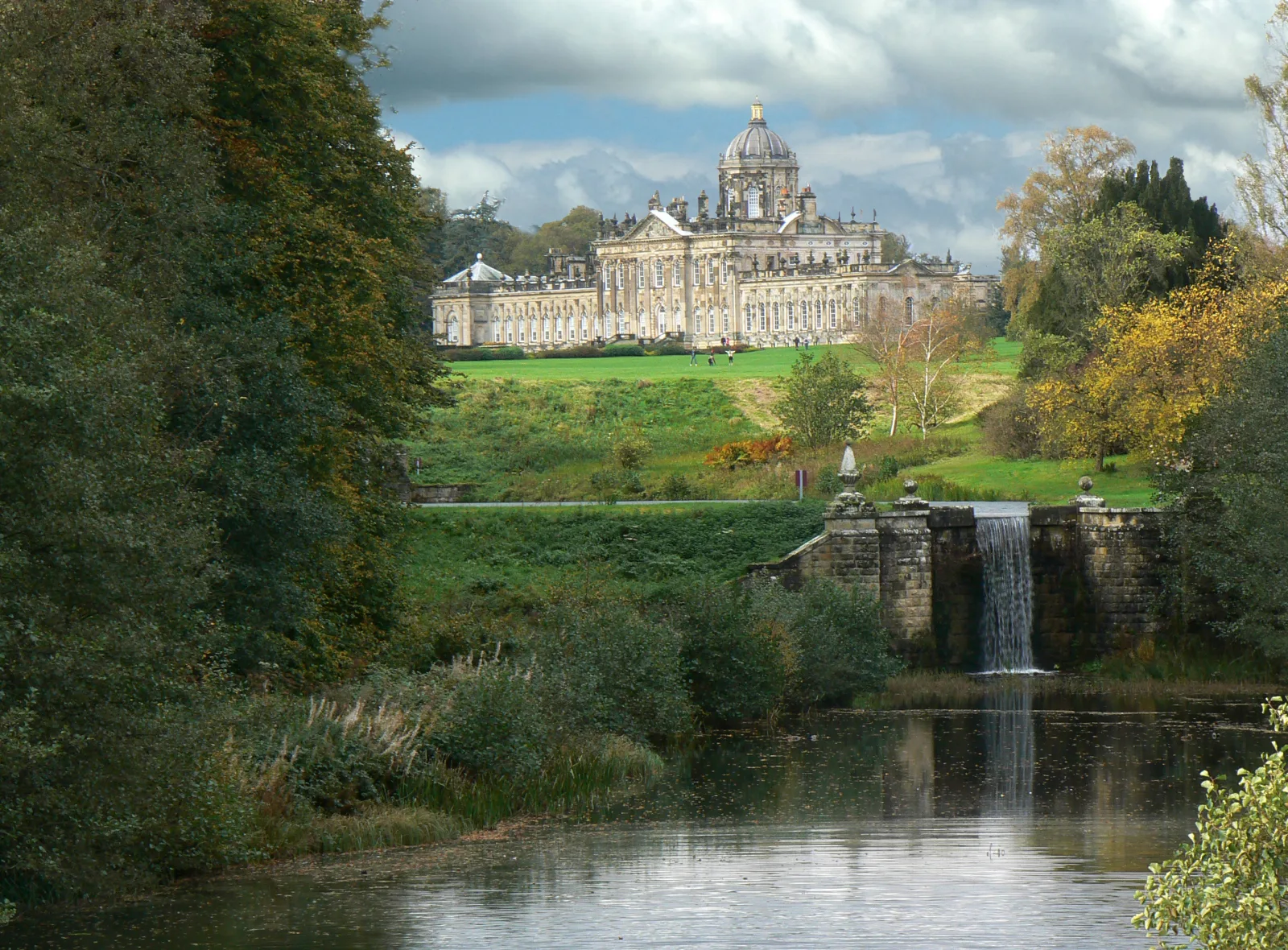Castle Howard and its landscaped grounds beneath a blue summer sky