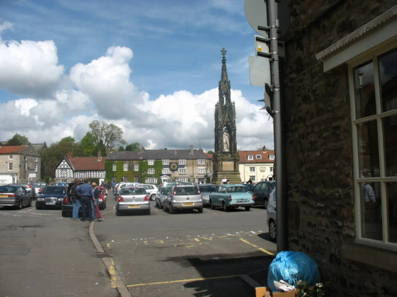 Helmsley Market Square on a clear day with stone buildings and shops